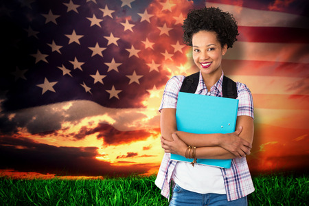 Casual young woman with folder in office against composite image of united states of america flagの写真素材