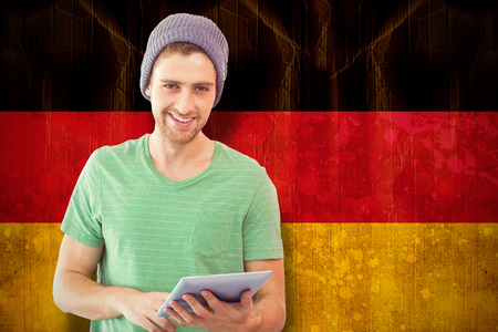 Student using tablet against germany flag in grunge effect
