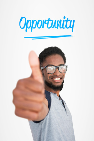 The word opportunity and casual young man gesturing thumbs up against white background with vignetteの写真素材
