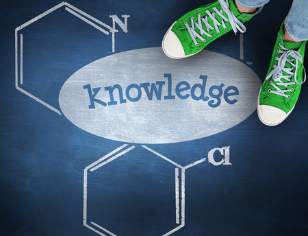 The word knowledge and casual shoes against blue chalkboard