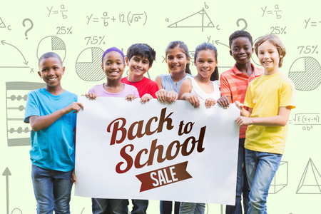 Happy friends in the park  against back to school sale message Happy friends in the park on a sunny dayの写真素材