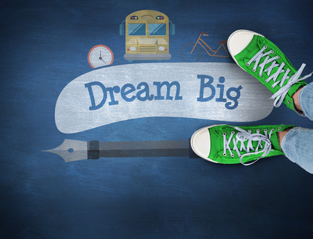 The word dream big and casual shoes against blue chalkboard