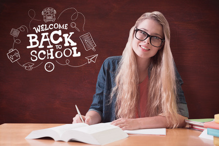 Student studying in the library  against deskの写真素材