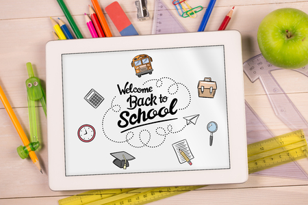 back to school against students desk with tablet pcの写真素材