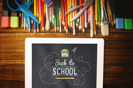 back to school against students desk with tablet pcの写真素材