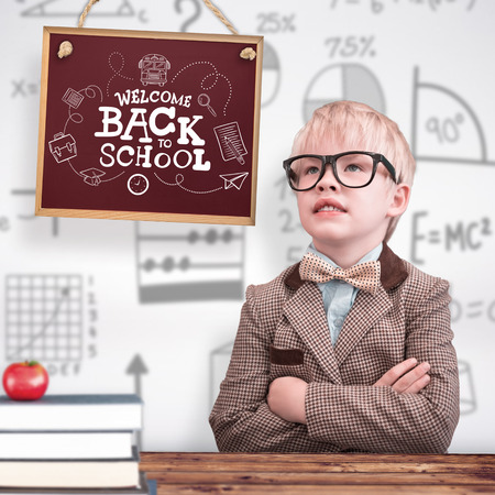 Cute pupil dressed up as teacher  against wooden planks backgroundの写真素材