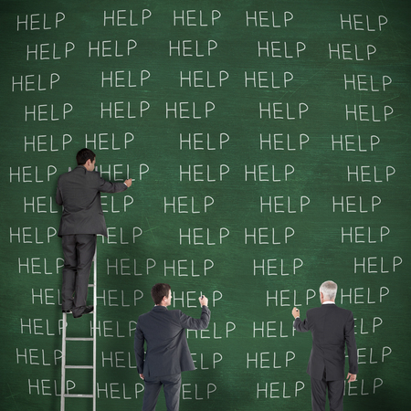 Business team writing against green chalkboardの写真素材