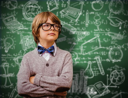 Cute pupil dressed up as teacher against green chalkboard