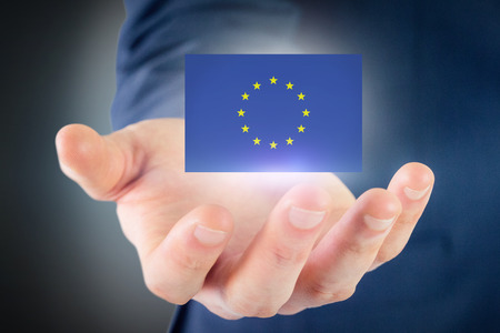 Close up view of businessman hand against blue background with vignette