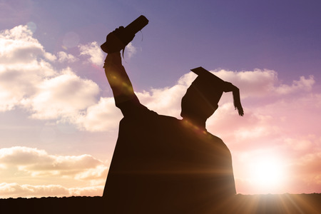 Silhouette of graduate against sun shiningの写真素材