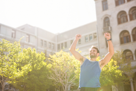 Happy handsome athlete triumphing in the cityの写真素材