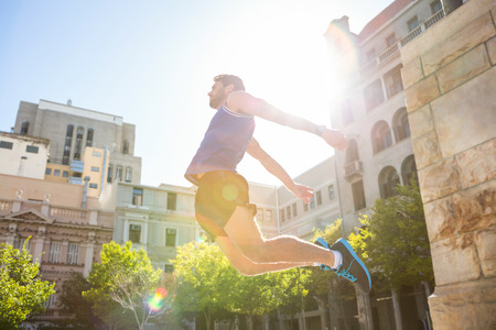 Handsome athlete jumping in the cityの写真素材