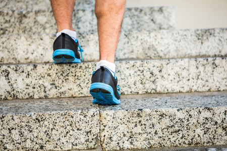 Athlete jogging up the stairs in the city