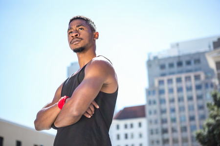 An handsome athlete looking away on a sunny day