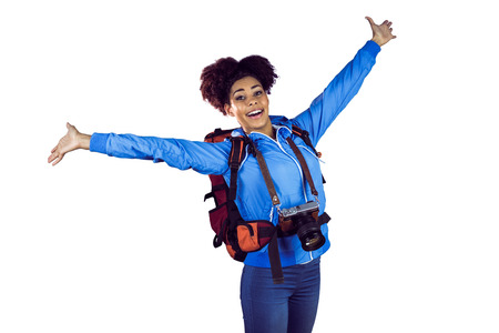 Ecstatic young woman with arms in the air against a white background