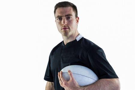 Portrait of a rugby player holding a rugby ballの写真素材