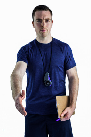 Smiling trainer holding a clipboard and greetingの写真素材