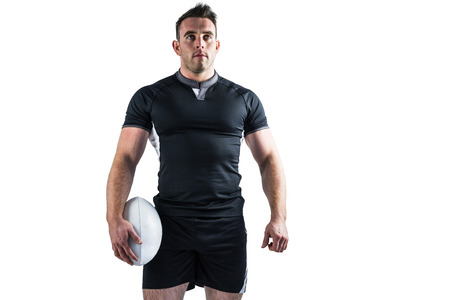 Tough rugby player holding ball on white backgroundの写真素材