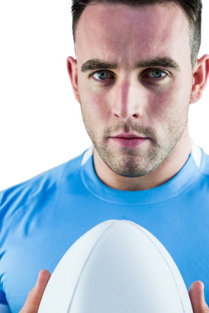 Rugby player looking at camera with ball on white backgroundの写真素材