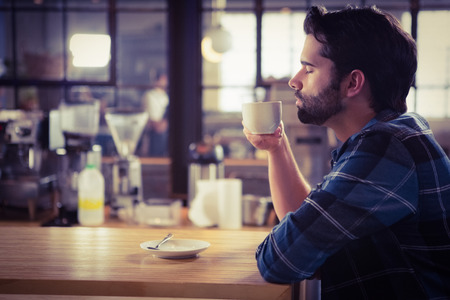 Worried man drinking a coffee at the cafe