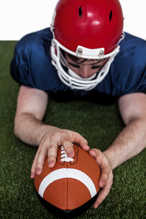 Determined american football player scoring a touchdown on the fieldの写真素材