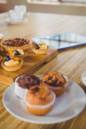 Pies on a wooden table in a cafeの写真素材