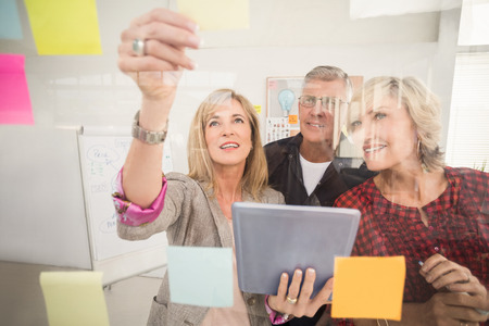 Business team working on tablet and sticky note at officeの写真素材