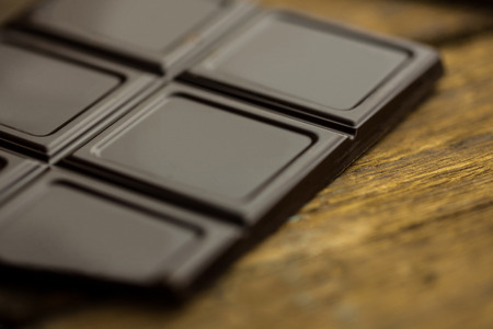 Close up view of pieces of chocolate on a wooden tableの写真素材