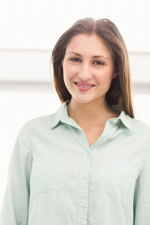 Portrait of pretty casual businesswoman smiling in the officeの写真素材