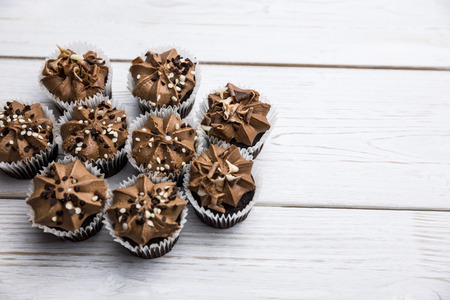 Chocolate cupcakes on a table shot in studioの写真素材