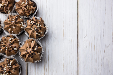 Chocolate cupcakes on a table shot in studioの写真素材