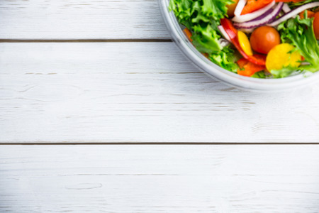 Healthy bowl of salad on table shot in studioの写真素材
