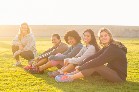 Portrait of smiling sporty women looking at camera in parklandの写真素材