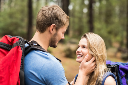Young happy hiker couple looking at each other in the natureの写真素材