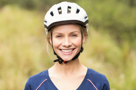 Young pretty happy biker looking at camera in the natureの写真素材