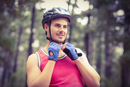 Handsome young biker looking away in the natureの写真素材
