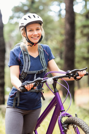Young pretty happy biker looking at camera in the natureの写真素材