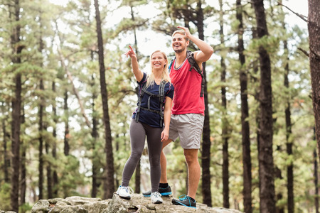 Young happy hiker couple looking away in the natureの写真素材