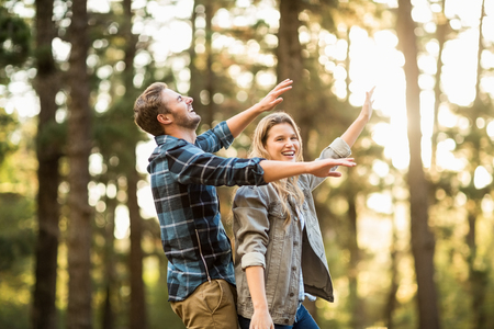 Smiling happy couple dancing in the natureの写真素材