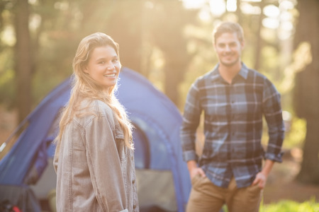Happy young camper couple smiling at the camera in the natureの写真素材