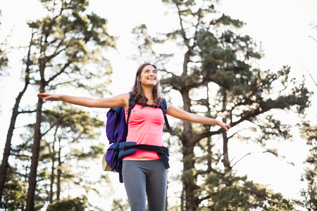 Young happy jogger standing on rock feeling free in the natureの写真素材