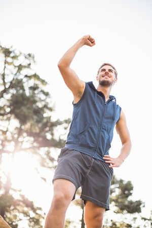 Young happy jogger looking in the distance cheering in the natureの写真素材