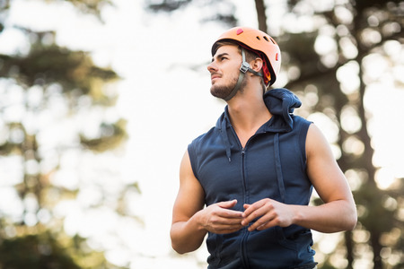 Handsome young hiker looking away in the natureの写真素材