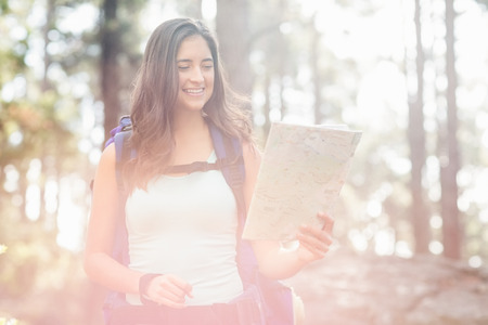 Young happy jogger looking at map in the natureの写真素材
