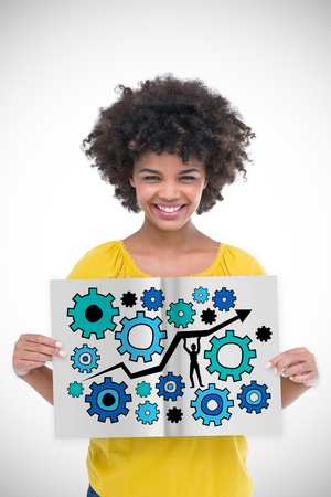 Pretty girl showing a book against white background with vignetteの写真素材