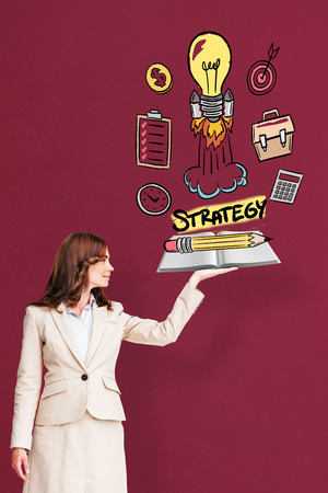 Businesswoman showing a book against red backgroundの写真素材