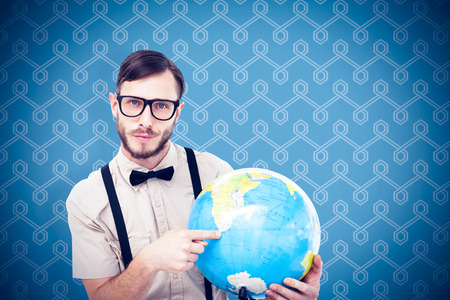 Geeky hipster holding a globe against backgroundの写真素材