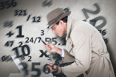 Spy looking through magnifier against white and grey backgroundの写真素材