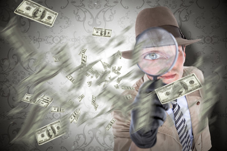 Spy looking through magnifier against elegant patterned wallpaper in grey tonesの写真素材