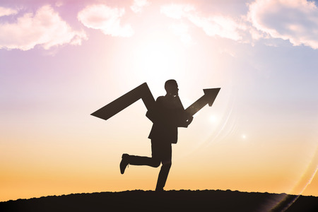 businessman with arrow against sun shiningの写真素材